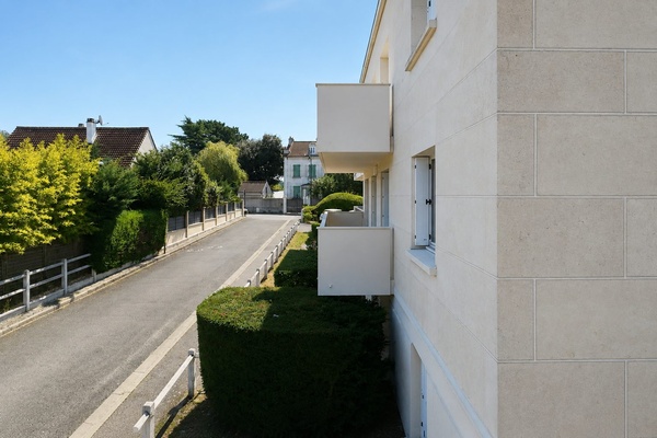 La vue depuis le balcon sur l'entrée de la résidence et sa voie d'accès
